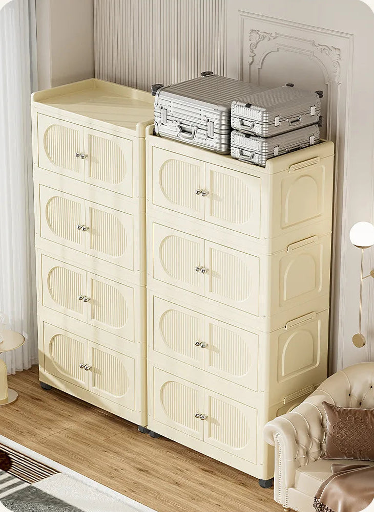 Beige storage cabinet with multiple doors holding a suitcase and box, against a white wall.